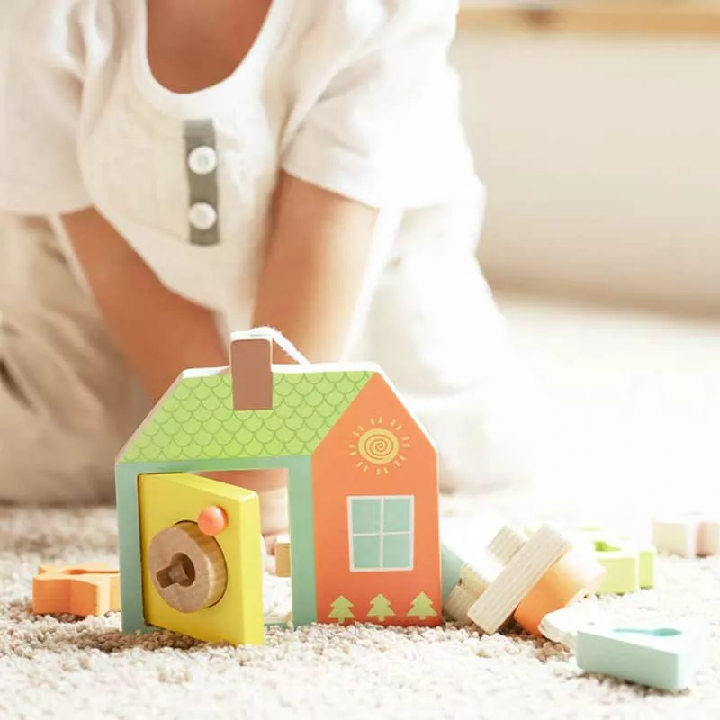 Children's wooden house shape sorter with different locks