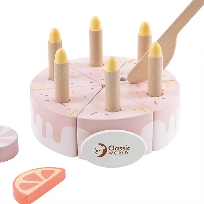 Children's wooden cake with candles in a pastel pink color.