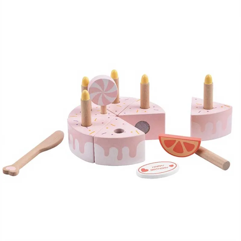 Children's wooden cake with candles in a pastel pink color.