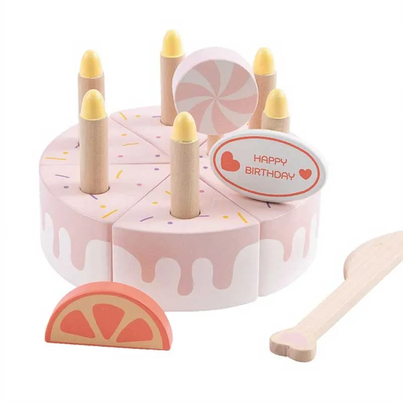 Children's wooden cake with candles in a pastel pink color.