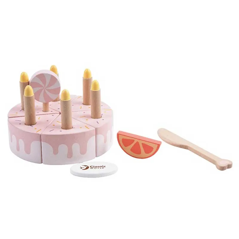 Children's wooden cake with candles in a pastel pink color.
