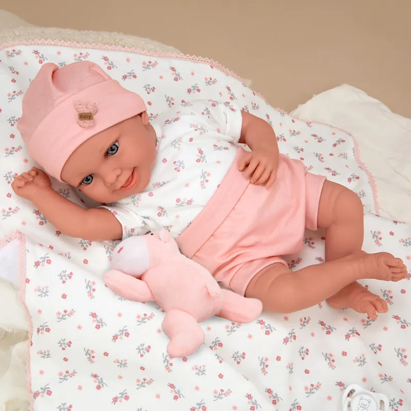 Smiling baby doll Colleen in pink with a blanket and a plush toy, actual weight - 40 cm