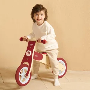 Wooden balance bike Classic World in burgundy color, for ages 2 and up.